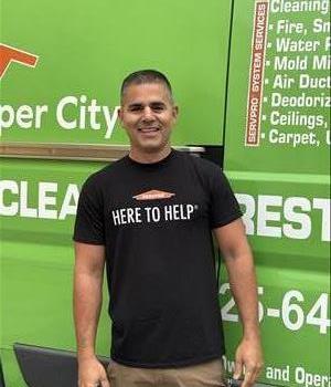 Yoandi in front of a SERVPRO vehicle